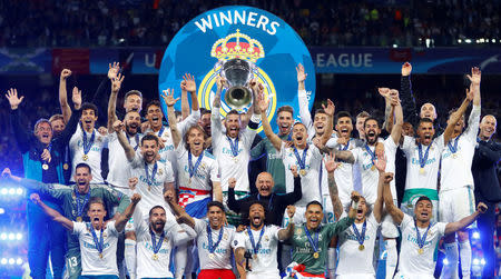 Soccer Football - Champions League Final - Real Madrid v Liverpool - NSC Olympic Stadium, Kiev, Ukraine - May 26, 2018 Real Madrid celebrate winning the Champions League with the trophy REUTERS/Kai Pfaffenbach