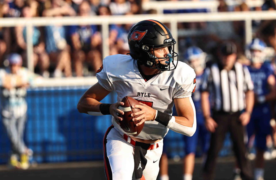 Ryle quarterback Logan Verax (7) looks to pass during their football game against Covington Catholic Friday, Aug. 18, 2023.