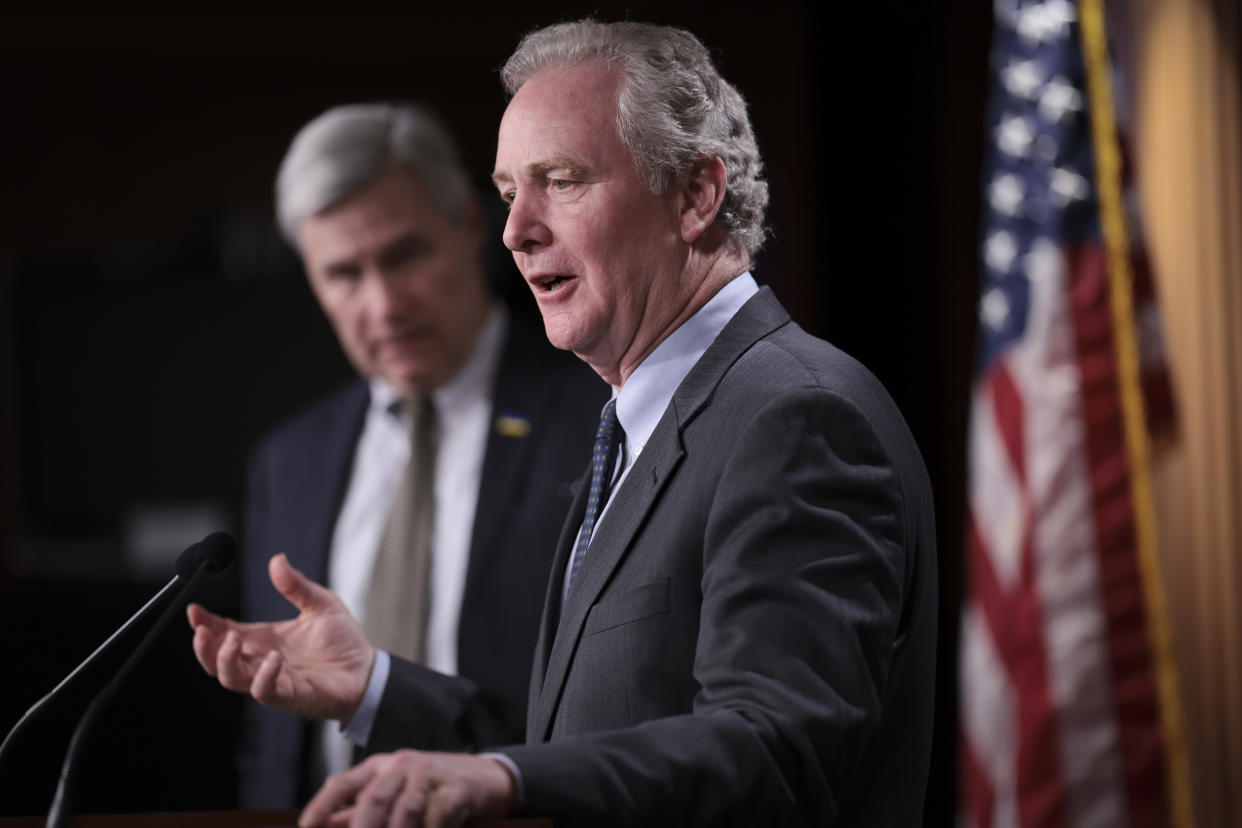 Sen. Chris Van Hollen, D-Md., with Whitehouse behind him, at a Capitol press conference on March 9.