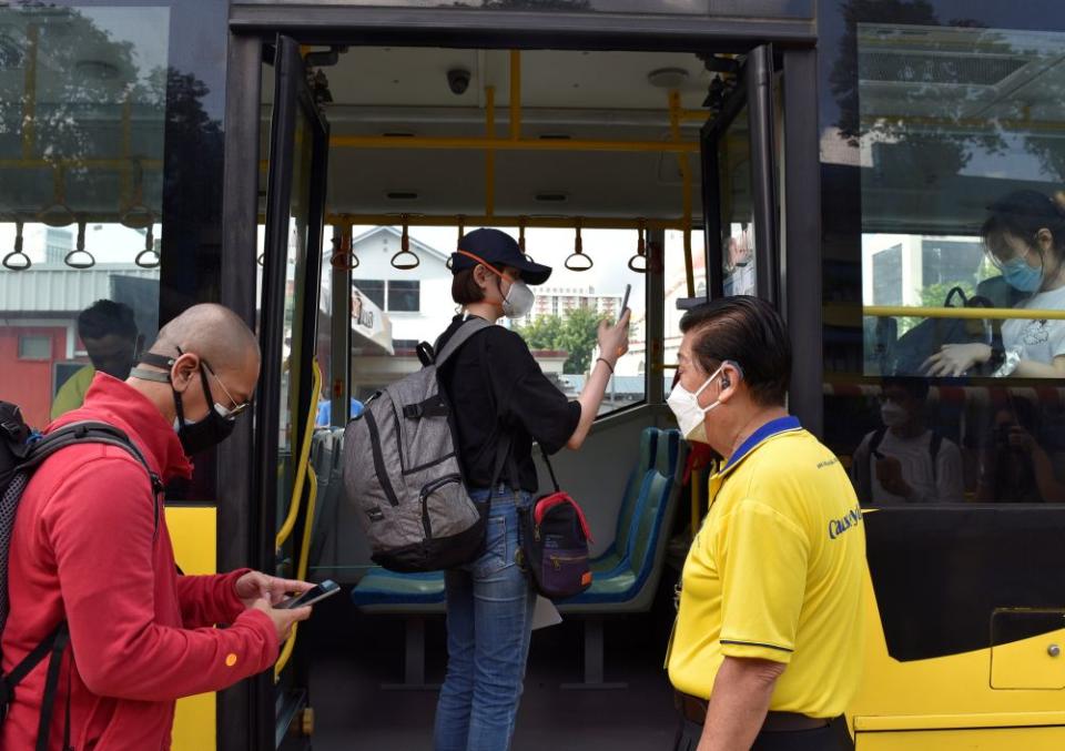 People board a bus back to Malaysia as the Vaccinated Travel Lane between Singapore and Malaysia opened November 29, 2021. — Reuters pic