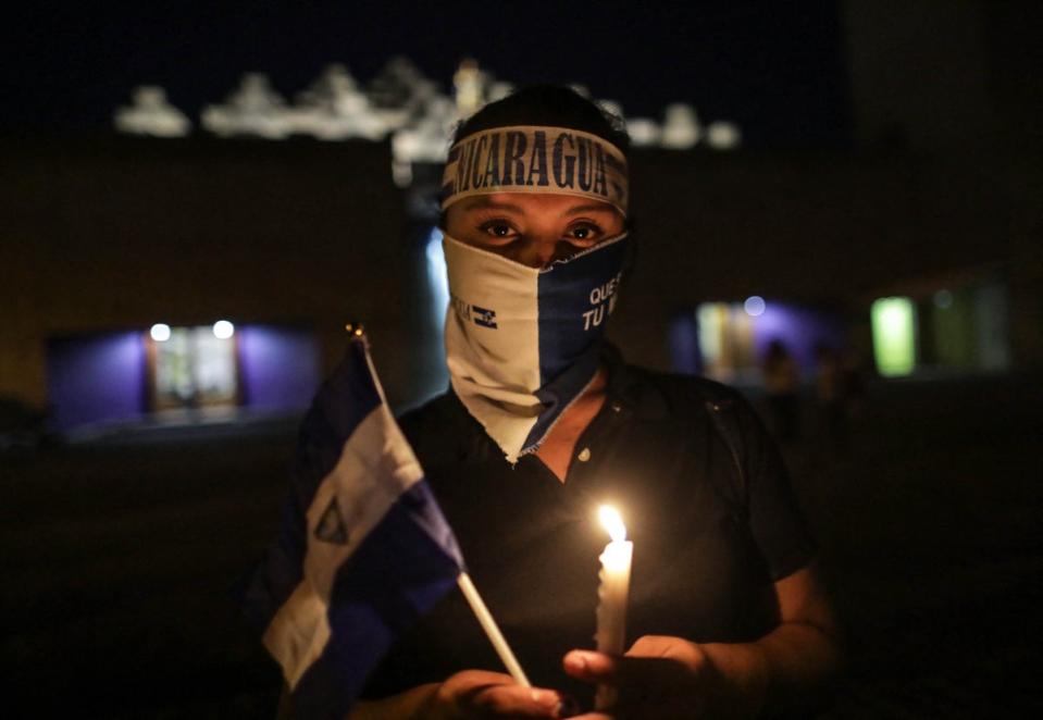 A demonstrator takes part in a vigil to demand the release of political prisoners (AFP/Getty)