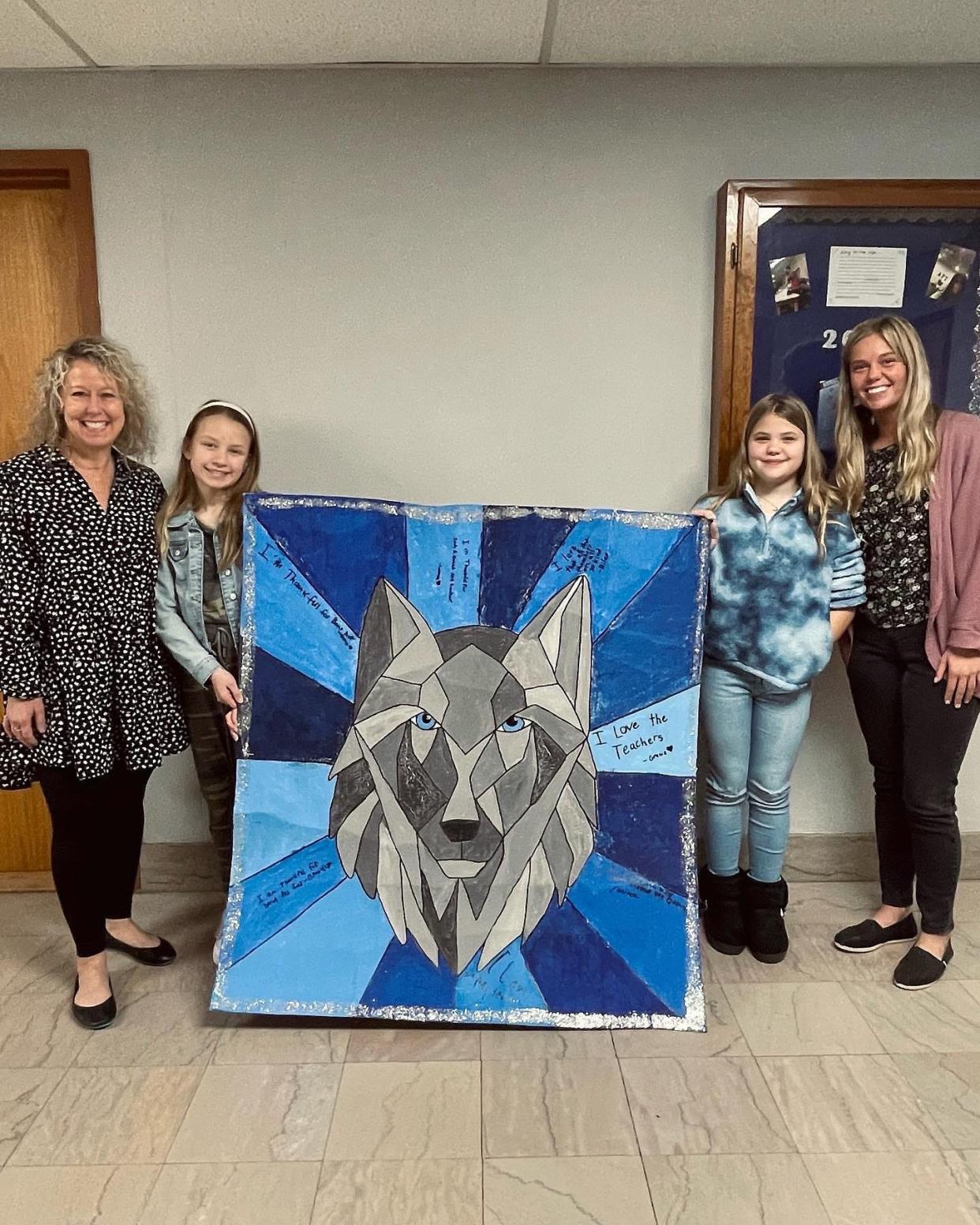 At the School Board Appreciation celebration, students Lainey Wilson and Riley Chamblin presented the fifth grade project to the board members. Pictured from left to right are Principal Jackie Noble, Lainey Wilson, Riley Chamblin, and art teacher Sidney Smith.