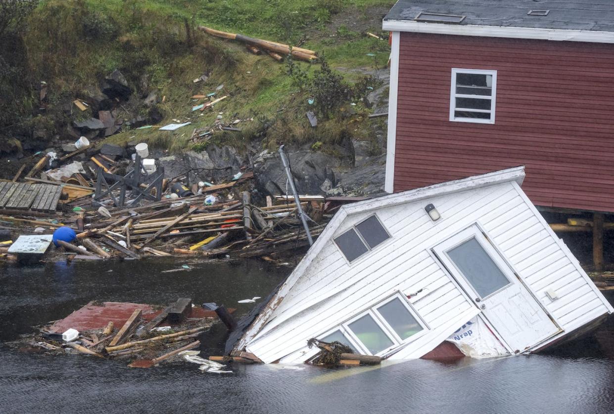 Damaged buildings sit in the water along the shore following Hurricane Fiona in Rose Blanche-Harbour Le Cou, N.L. in September, 2022. Fiona left a trail of destruction across much of Atlantic Canada. THE CANADIAN PRESS/Frank Gunn