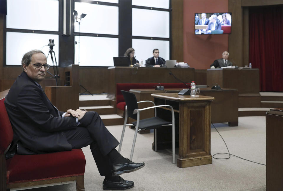 Catalan President Quim Torra sits in court in Barcelona, Spain, Monday, Nov.18, 2019. The pro-independence regional president of Catalonia is standing trial for allegedly disobeying Spain's electoral board by not removing pro-secession symbols from public buildings during an election campaign. Quim Torra could be declared unfit to hold public office for a period of time if found guilty in the trial that started Monday. (Andreu Dalmau, Pool photo via AP)