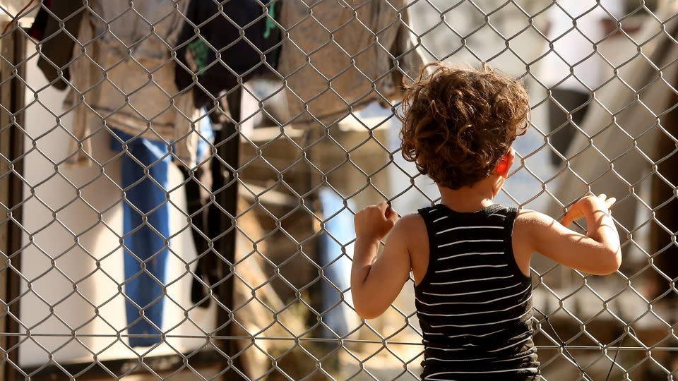A refugee child looks through a fence at the Moria refugee camp on May 20, 2018 in Mytilene, Greece. - Adam Berry/Getty Images