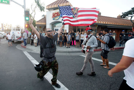 Demonstrators protest during an America First rally in Laguna Beach, California, U.S., August 20, 2017. REUTERS/Sandy Huffaker