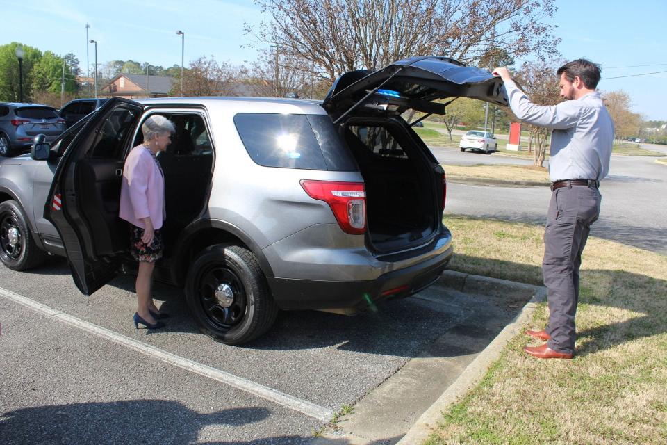 Kathy Murphy, president of Gadsden State Community College, and Jay Freeman, chief of the school's Police and Public Safety Department, survey the fully-equipped patrol vehicle given to the college for $1 from the City of Hokes Bluff.