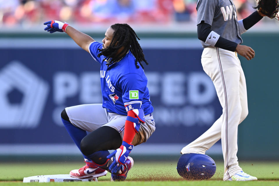 Toronto Blue Jays Vladimir Guerrero Jr., left, slides into second base for a double during the first inning of a baseball game against the Washington Nationals, Friday, May 3, 2024, in Washington. (AP Photo/John McDonnell)