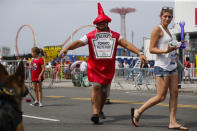 <p>People attend the annual Nathan’s Hot Dog Eating Contest In 2017 winner Joey Chestnut set a Coney Island record eating 72 hot dogs. (Photo: Eduardo Munoz Alvarez/Getty Images) </p>
