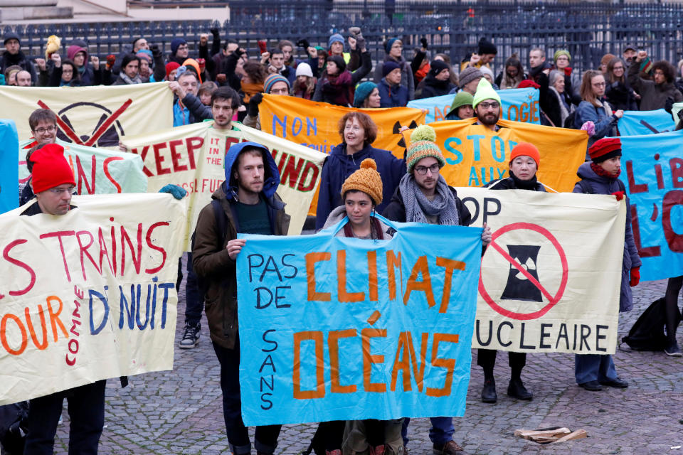 Environmental activists display banners during a protest in support of the Paris climate accord as part of the One Planet Summit in Paris, France, December 12, 2017. REUTERS/Charles Platiau