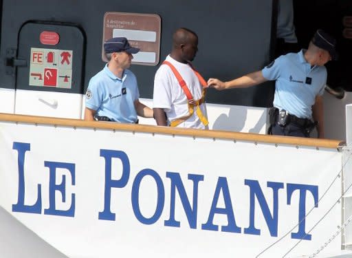 French police escort a suspected Somali pirate during a reconstruction of events surrounding the hijacking of the luxury sailing ship "Le Ponant" in 2008. Le Ponant left the Seychelles on March 30, 2008 with 30 crew and no passengers on board, headed for Yemen where they were to take on passengers for a cruise. On route the ship was boarded by pirates