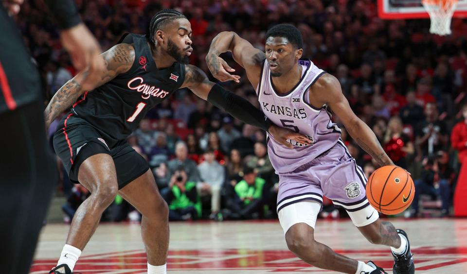 Kansas State guard Cam Carter (5) drives against Houston's Jamal Shead (1) during their Big 12 game Saturday at Fertitta Center in Houston.