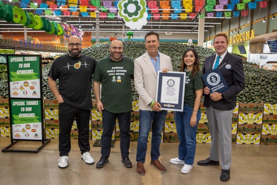 Employees at El Rio Grande Latin Market the day their store won a Guinness World Record for the largest fruit display.