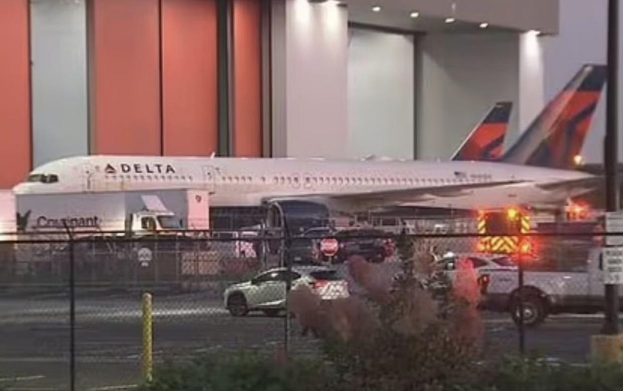 Emergency vehicles are seen parked near the plane at Hartsfield-Jackson Atlanta International Airport