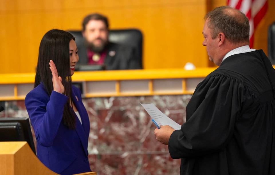 Lily Wu takes the oath of office to become mayor of Wichita. Giving the oath is Judge Tyler Roush.