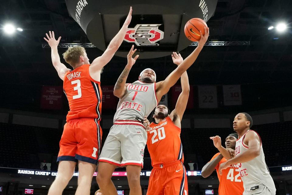 Feb 1, 2024; Columbus, Ohio, USA; Ohio State Buckeyes guard Roddy Gayle Jr. (1) shoots between Illinois Fighting Illini forward Marcus Domask (3) and forward Ty Rodgers (20) during the second half of the NCAA men’s basketball game at Value City Arena. Ohio State lost 87-75.