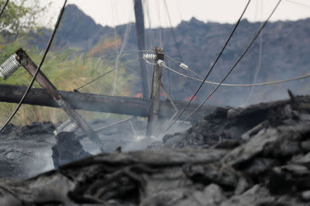 Utility poles and power lines sit destroyed in the Kilauea lava flow on Pohoiki Road near Pahoa, Hawaii, U.S., May 29, 2018. REUTERS/Marco Garcia