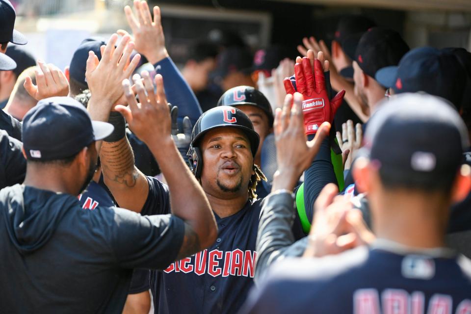 Cleveland Guardians' Jose Ramirez celebrates in the dugout after scoring on a three-run home run by Kole Calhoun on Aug. 30 in Minneapolis.