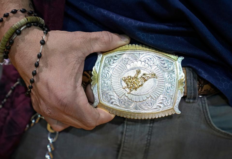 Jerred Mcpherson, 24, shows off a belt buckle Wednesday that he said he won bull riding in Tennessee. He and his fiancee were at Broad Street United Methodist Church, where a warming center is operated and the Community Shelter Board was conducting its annual count of homeless people.