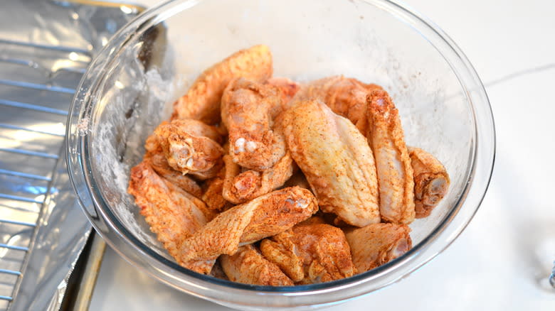 Dry-brined chicken wings in  glass bowl