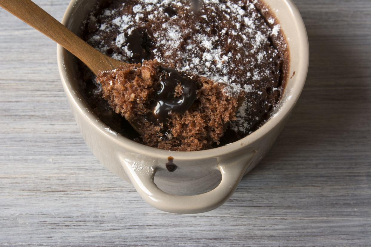 Chocolate Brownie in a bowl, individual portion, with a wooden spoon