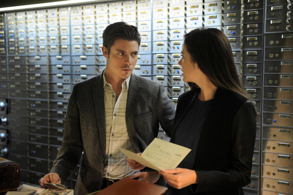 A scene where Josh Henderson and Julie Gonzaloin are standing in front of the safe deposit box wall and arguing.