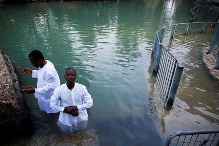 Christian tourists from Nigeria take part in a ceremony at the Yardenit baptismal site, in the Jordan River, which flows out from the Sea of Galilee, northern Israel November 30, 2016. REUTERS/Ronen Zvulun /File Photo