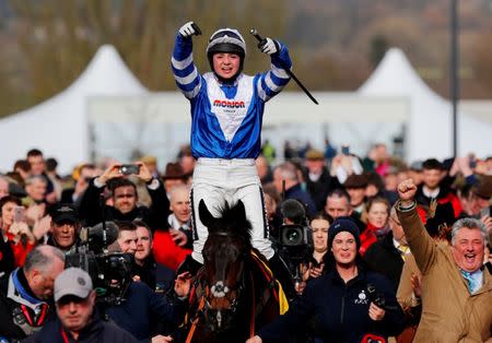 FILE PHOTO: Horse Racing - Cheltenham Festival - Cheltenham Racecourse, Cheltenham, Britain - March 14, 2019 Bryony Frost celebrates on Frodon after winning the 2.50 Ryanair Chase as trainer Paul Nicholls (R) looks on REUTERS/Eddie Keogh