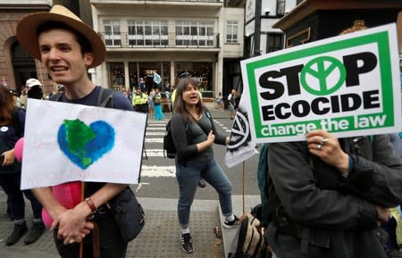 Extinction Rebellion climate activists hold a protest outside the Royal Courts of Justice in London