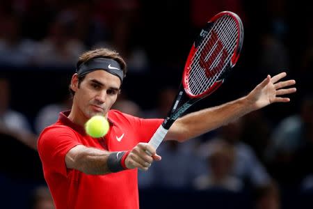 Switzerland's Roger Federer returns a shot during his men's singles tennis match against Lucas Pouille of France in the third round of the Paris Masters tennis tournament at the Bercy sports hall in Paris, October 30, 2014. REUTERS/Benoit Tessier