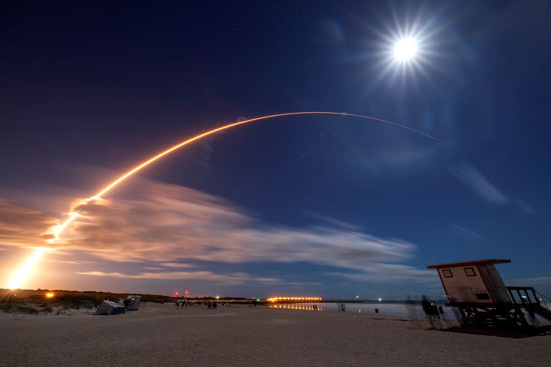 The Solar Orbiter spacecraft, built for NASA and the European Space Agency, lifts off from pad 41 aboard a United Launch Alliance Atlas V rocket as the full moon is seen above at the Cape Canaveral Air Force Station in Cape Canaveral