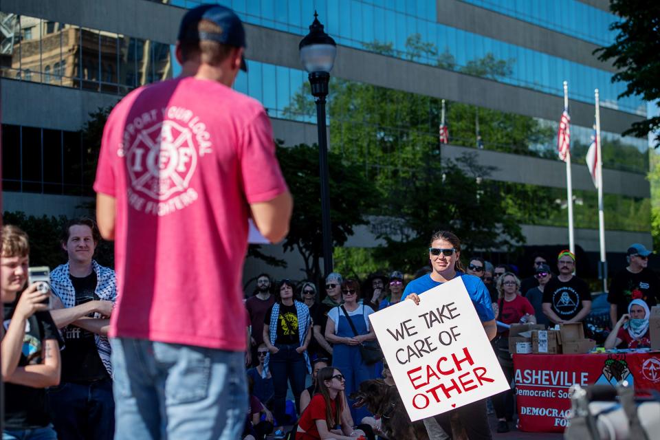 Welcker Taylor, president of the Asheville Fire Fighters Association, speaks at a May Day rally in Pack Square, May 1, 2024.