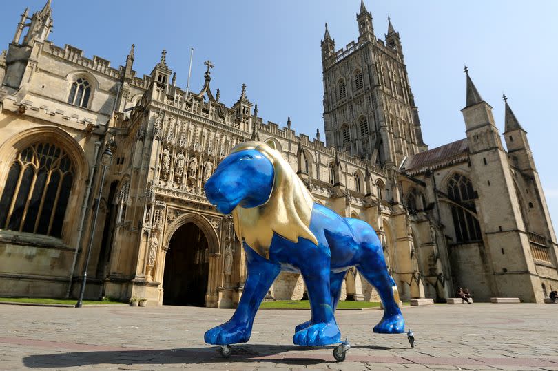 A lion sculpture outside Gloucester Cathedral