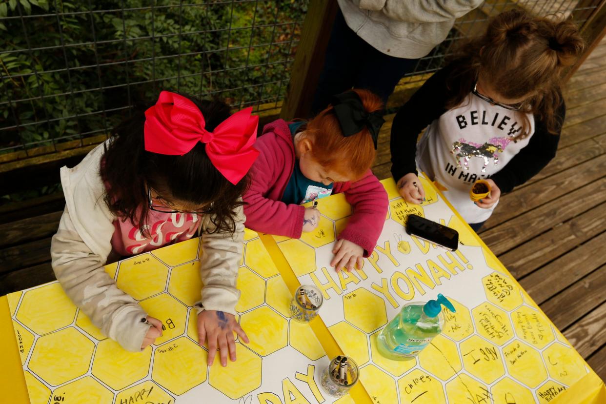 Kids sign birthday cards for Bear Hollow Zoo's three black bears during the zoo's "Bears' Bee-Day" event on Saturday, March 19, 2022.