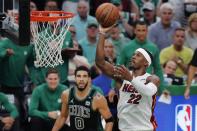 Miami Heat's Jimmy Butler (22) shoots against Boston Celtics' Jayson Tatum (0) during the second half of Game 6 of the NBA basketball playoffs Eastern Conference finals Friday, May 27, 2022, in Boston. (AP Photo/Michael Dwyer)