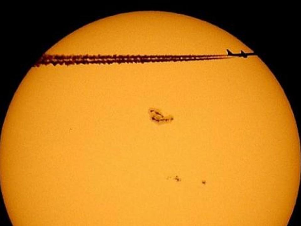 A sunstop is seen on the sun as a passing plane flies before it