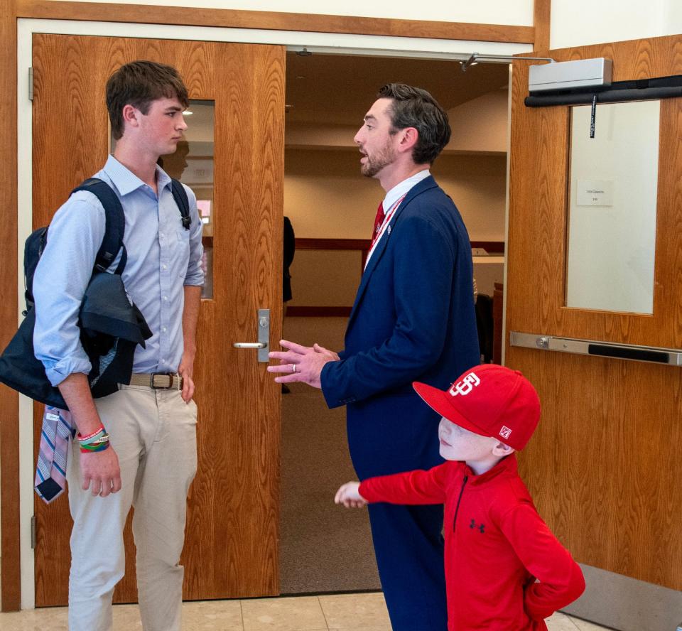 St. John’s High School baseball player Brady Shea talks with new coach Casey Cummins, and Cummins’ 5-year-old son Kyle, Wednesday, October 4, 2023.