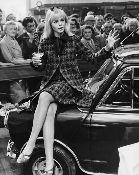  Actress Britt Ekland sitting on the Mini her husband Peter Sellers bought for her birthday, at the Radford Motor Company showroom - HULTON ARCHIVE 