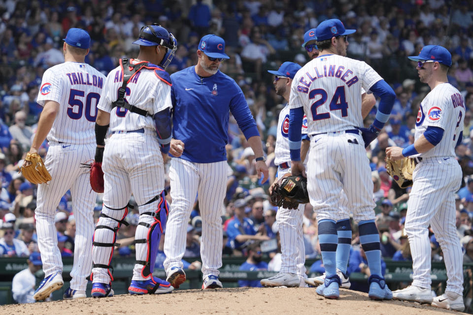 Chicago Cubs manager David Ross, center, talks to players after he pulled starting pitcher Jameson Taillon (50) during the sixth inning of a baseball game against the Baltimore Orioles in Chicago, Sunday, June 18, 2023. (AP Photo/Nam Y. Huh)