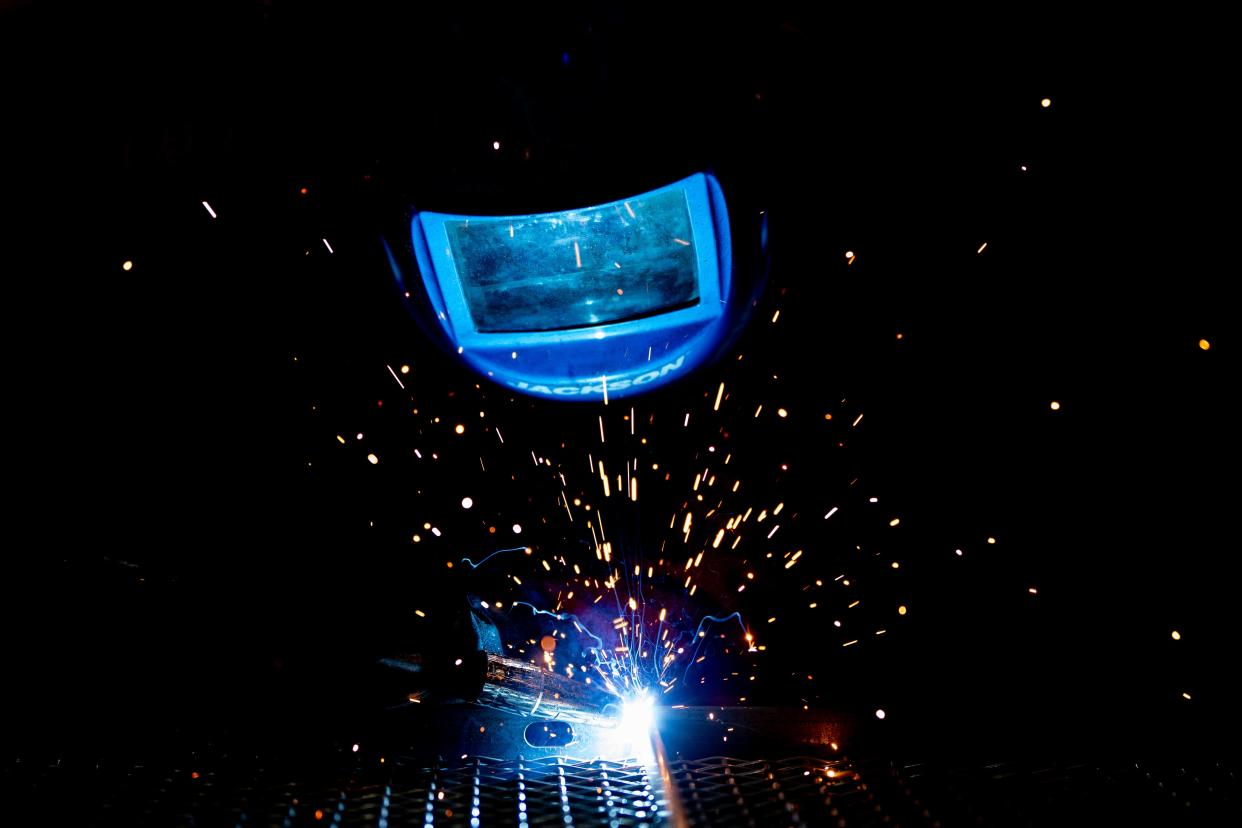 Danielle Roberts welds together a wire screen to a frame during her shift at Wire Crafters on Wednesday, March 20, 2024.