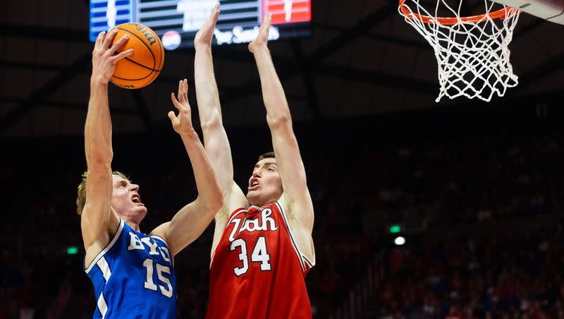 Brigham Young Cougars guard Richie Saunders (15) shoots the ball over Utah Utes center Lawson Lovering (34) during a men’s basketball game at the Jon M. Huntsman Center in Salt Lake City on Saturday, Dec. 9, 2023.
