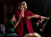 Democratic 2020 U.S. presidential candidate and U.S. Senator Elizabeth Warren (D-MA) dances with a boy at a campaign event in Ames