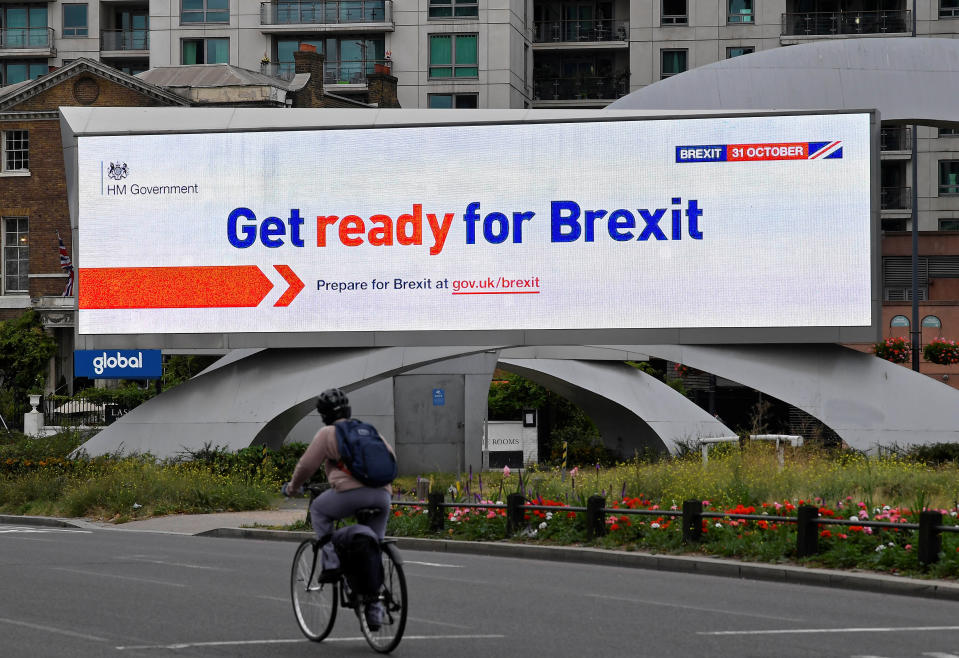 A cyclist rides past an electronic billboard displaying a British government Brexit information awareness campaign advertisement in London, Britain, September 11, 2019. REUTERS/Toby Melville.