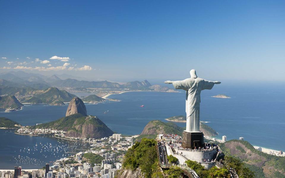 <p>Known as one of Rio de Janeiro’s most iconic landmarks, the <a rel="nofollow noopener" href="http://www.travelandleisure.com/travel-guide/rio-de-janeiro/things-to-do/christ-the-redeemer" target="_blank" data-ylk="slk:Christ the Redeemer;elm:context_link;itc:0;sec:content-canvas" class="link ">Christ the Redeemer</a> statue typically tops visitor’s must-see lists. It stands 98 feet tall and sits at the summit of Mount Corcovado. The lines may be long, but just be thankful that escalators and elevators have been installed. Before 2002, visitors had to climb more than 200 steps to reach the statue. </p>