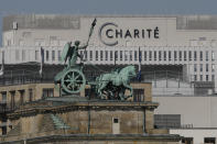 FILE - In this Sept. 14, 2020 file photo, the Quadriga on top of Germany's landmark Brandenburg Gate seen in front of the central Charite building, where Russian opposition leader Alexei Navalny is treated, in Berlin, Germany. The German hospital treating Russian opposition leader Alexei Navalny for poisoning says his condition improved enough for him to be released from the facility. The Charite hospital in Berlin said Wednesday that after 32 days in care, Navalny’s condition “improved sufficiently for him to be discharged from acute inpatient care.” (AP Photo/Markus Schreiber)