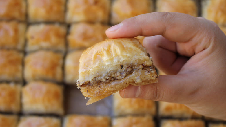 Fingers holding baklava