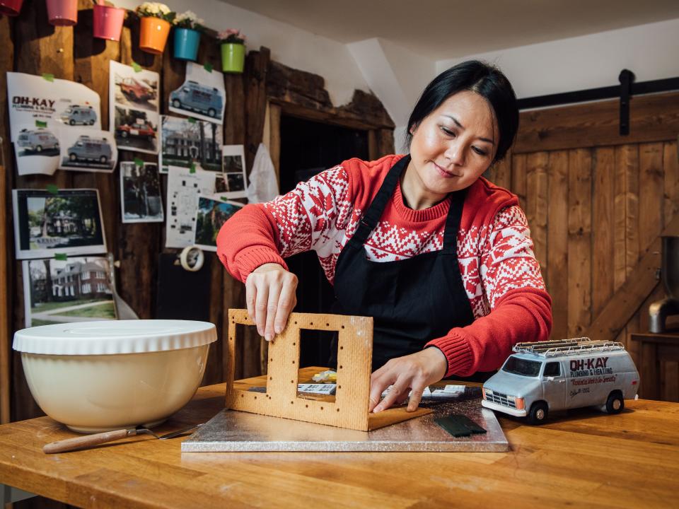 Cake designer Michelle Wibowo works on her gingerbread version of the McCallister house