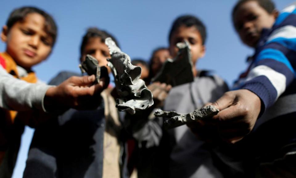 Boys hold missile shrapnel they collected from the site of a Saudi-led air strike in Sanaa, Yemen. Canberra-made weapons are being sold to Saudi Arabia. 