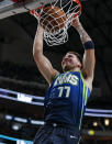 Dallas Mavericks forward Luka Doncic dunks during the first half of an NBA basketball game against the San Antonio Spurs, Thursday, Dec. 26, 2019, in Dallas. (AP Photo/Brandon Wade)