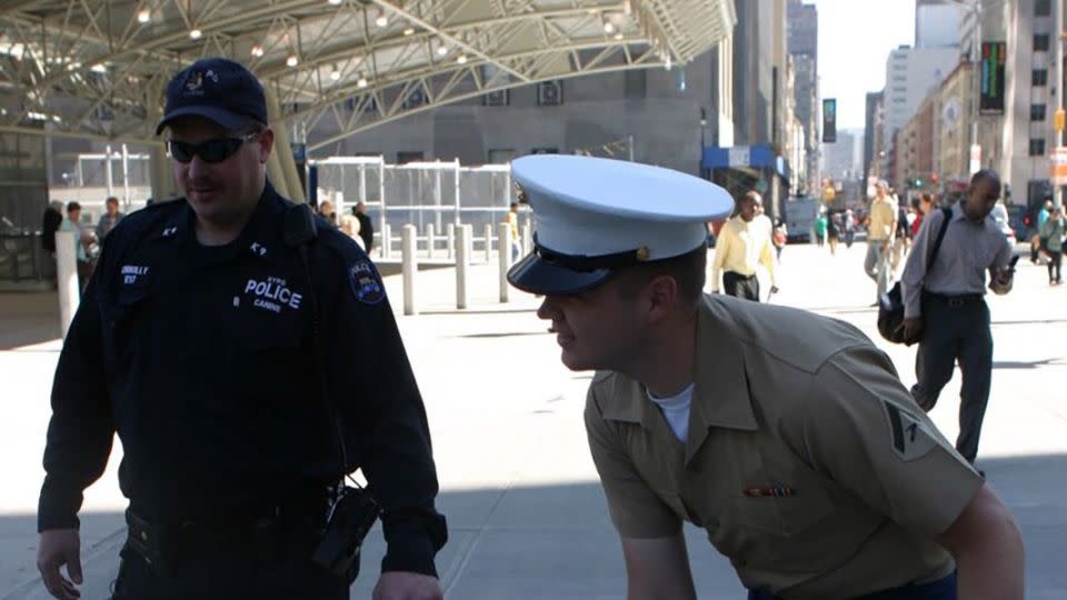 J.D. Vance petting a K-9 near Ground Zero while waiting for the 24th Marine Expeditionary Unit to arrive to lay a wreath at the site as part of the 18th annual Fleet Week in New York City in 2005. - Curtis Keester